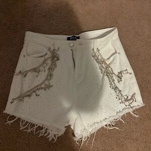 White Jean Shorts with Distressed Detailing and Raw Hem